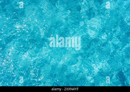 Clear blue pool water shimmering in the sunlight. Stock Photo
