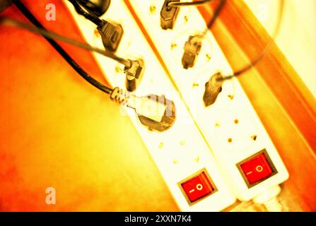 Eletric plugs in two power strips Stock Photo