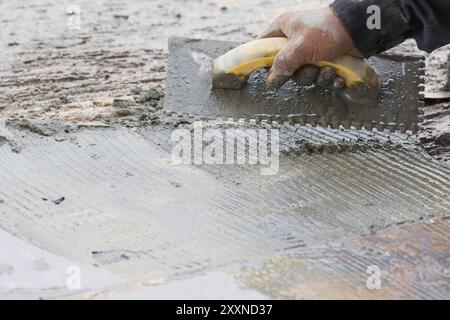 Mason was repaired for the floor tiles Stock Photo