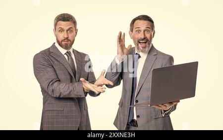 photo of amazed businessmen freelancer with laptop. two businessmen freelancer using laptop. Stock Photo