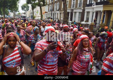 London, UK. 25th Aug, 2024. Revellers dressed as children's puzzle book character Wally take part in the parade on the first day of this year's Notting Hill Carnival. The annual event in London's popular Notting Hill area attracts around a million people and is primarily a celebration of Caribbean culture. (Photo by Vuk Valcic/SOPA Images/Sipa USA) Credit: Sipa USA/Alamy Live News Stock Photo