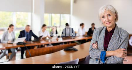Portrait of positive senior businesswoman in meeting room Stock Photo