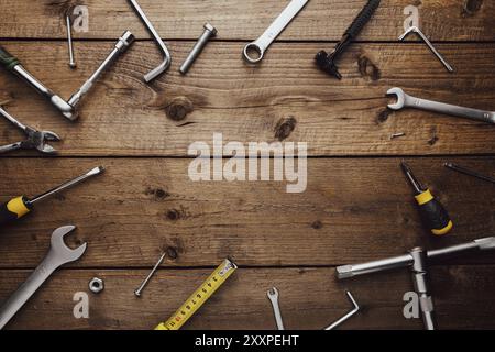 Flat lay with various work tools on wooden background working table. Top view on new hand tool set for repair, construction kit, overhead. Must-have f Stock Photo