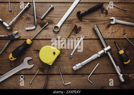 Flat lay with DYI composition of various work, carpentry tools knolled on brown wooden decks background pattern working table. Top view on new hand to Stock Photo
