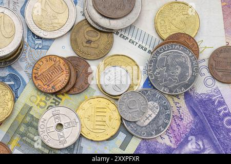 Assortment of coins on bank notes from different countries Stock Photo