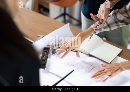 Architect collaboration on Blueprint Design at Office Desk with Tools and Notes Stock Photo
