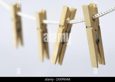 Den Helder, Netherlands. July 2022. Wooden clothes pegs on a white background, isolated. Selective focus Stock Photo