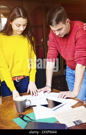 Business team at work with financial reports and a tablet computer Stock Photo