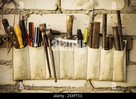Tools renovation on grunge old brick wall. Close up Stock Photo