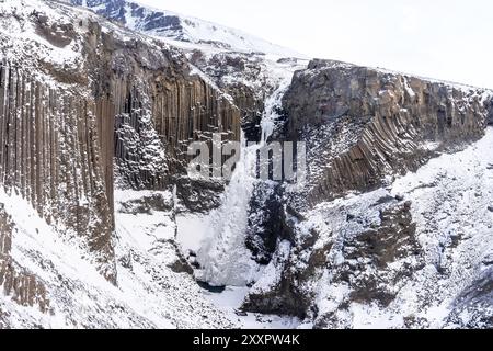 Hengifoss waterfall frozen in the cold winter of Iceland Stock Photo