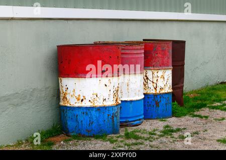 Old 44 gallon drums against wall, Western Australia Stock Photo