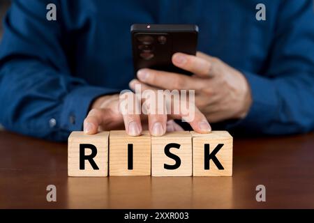 Businessman with the words Risk. Business risk management and growth performance. Risks assessment. Planning strategies and achieving goals. Stock Photo
