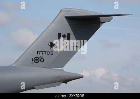 The tail section of 177705, a Boeing CC-177A Globemaster operated by the Royal Canadian Air Force (RCAF), at RAF Fairford in Gloucestershire, England. On the tail can be seen the insignia to mark the centennial anniversary of the RCAF, as the aircraft taxis in to participate in the Royal International Air Tattoo 2024 (RIAT24). Stock Photo