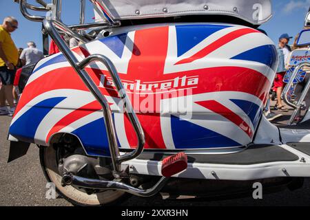 A Lambretta scooter with union flag paint work. Thousands attend the annual Mod Weekender held in the English seaside town of Brighton. This year celebrates the 60 year anniversary of the Battle Of Brighton which is one of the most famous Battle Of Brighton between the Mods and Rockers. In 1950s and 1960s the two youth sub-cultures came together in southern English seaside resorts to fight running battles between themselves and the police. This caused a moral public outcry by a conservative post war society which saw the perpetrators arrested, tried and imprisoned. Whilst the Rocker culture is Stock Photo