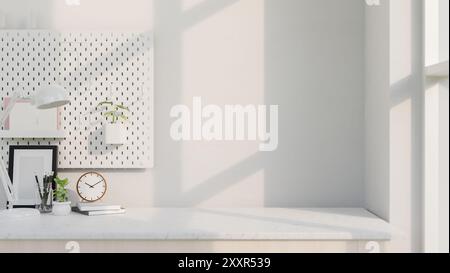 A copy space for displaying products on a white table by the window featuring accessories and a pegboard on a white wall. workspace, office desk, home Stock Photo
