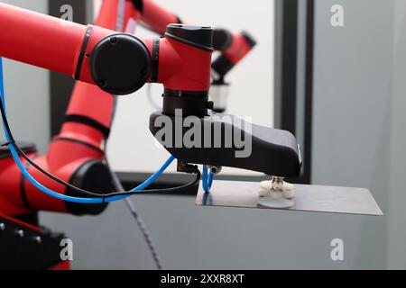 Industrial robotic manipulators on production line for an automated pick and place process with robots. Selective focus. Stock Photo