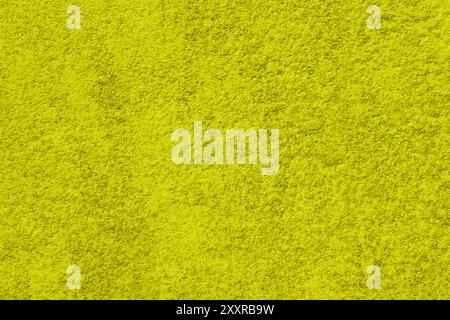 Old shabby, rough, yellow-green plaster close-up. Stock Photo
