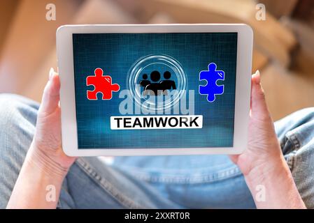 Tablet screen displaying a teamwork concept Stock Photo