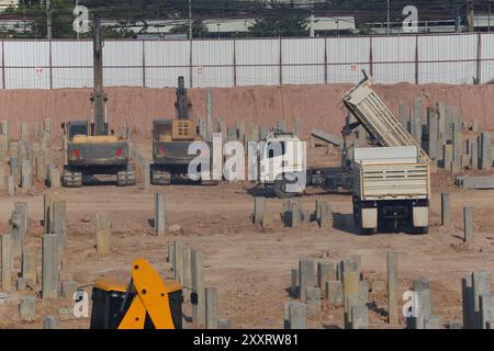 Construction work zones of piling where piles are driven into the ground for large construction projects with stable foundations. Stock Photo