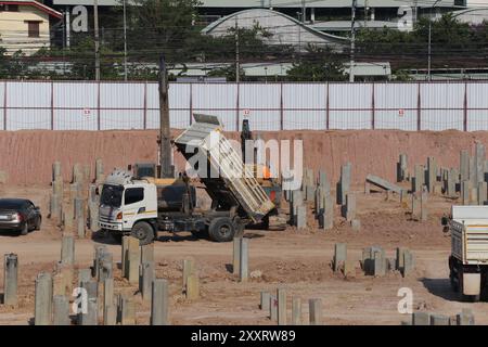 Construction work zones of piling where piles are driven into the ground for large construction projects with stable foundations. Stock Photo