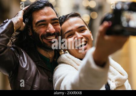 Two happy men taking a selfie while smiling and having fun Stock Photo