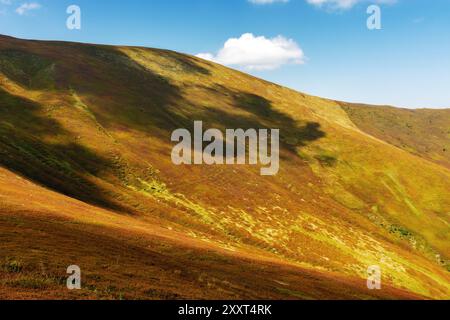 scenery with steep slopes of borzhava ridge. scenic carpathian mountain landscape in dappled light. popular travel destination of transcarpathia in la Stock Photo
