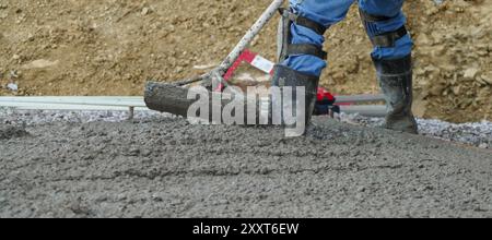 Manual spreading of concrete in a form Stock Photo