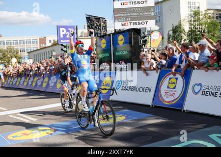 25 August 2024, Saarland, Saarbrücken: The Dane Mads Pedersen from Team Lidl-Trek is celebrating after winning the fourth stage and finishing first overall in the Deutschland Tour. Photo: Daniel Löb/dpa Stock Photo