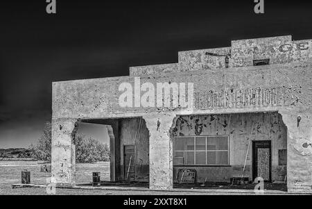 Amargosa Garage at Death Valley Junction.  Abandoned garage opposite the Amargosa Opera House. Mojave Desert. Black and White image. Stock Photo