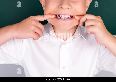 Photo of small boy showing smile dentist dental therapy clinic isolated on green color background Stock Photo