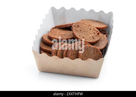 Rye bread  crackers in paper bowl isolated on white background Stock Photo