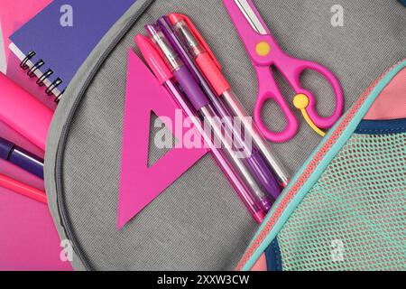 Flat lay composition with backpack and different school stationery on table Stock Photo