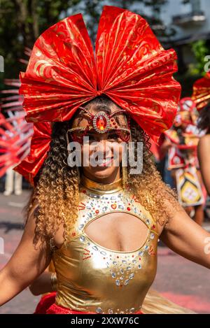 Notting Hill, London, UK. 26th Aug, 2024. Europe’s largest street festival is taking place in the streets of Notting Hill. Jamaican themed exotic dancers and musical groups are parading through the streets, with food and street entertainment around the area adding to the event. The Grand Parade takes place on Bank Holiday Monday as the culmination of the three-day festival, which began in 1966. Stock Photo