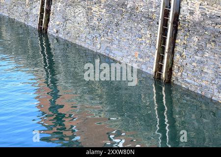 Harbour ladder reflected in water Stock Photo