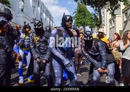 London, England, UK. 26th Aug, 2024. Revellers dressed as Batmen take part in a street party on the second day of this year's Notting Hill Carnival. The annual event in London's popular Notting Hill area attracts around a million people and is primarily a celebration of Caribbean culture. (Credit Image: © Vuk Valcic/ZUMA Press Wire) EDITORIAL USAGE ONLY! Not for Commercial USAGE! Credit: ZUMA Press, Inc./Alamy Live News Stock Photo