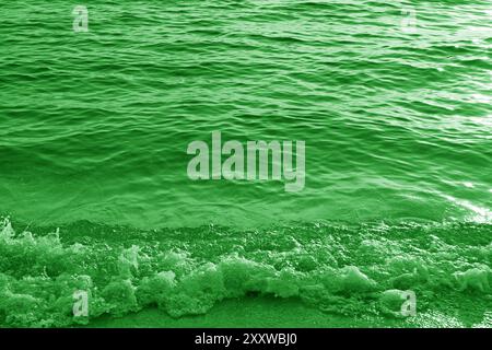 Pop art surreal style green colored splashing waves and sea ripples Stock Photo