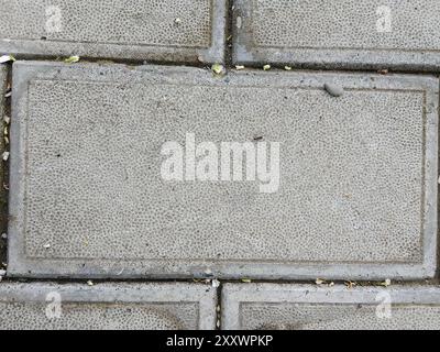 This image showcases an up-close view of urban pavement, highlighting the intricate mosaic created by rectangular concrete slabs laid in varying sizes Stock Photo