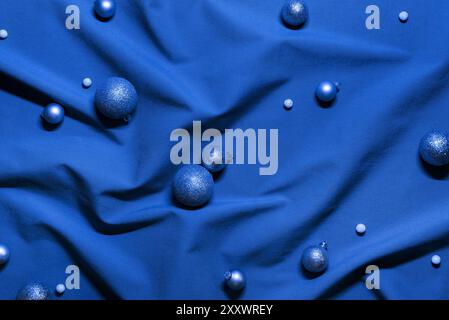 Abstract Christmas Background with Baubles on Blue Fabric Stock Photo