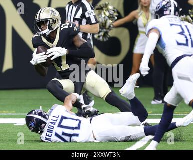 New Orleans, United States. 25th Aug, 2024. New Orleans Saints wide receiver A.T. Perry (17) tries to get some extra yardage after a huge gain while being brought down by Tennessee Titans cornerback Anthony Kendall (40) during a National Footbal League preseason game at the Caesars Superdome on Sunday, August 25, 2024 in New Orleans, Louisiana. (Photo by Peter Forest/SipaUSA) Credit: Sipa USA/Alamy Live News Stock Photo