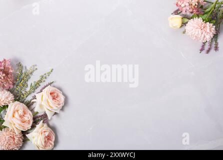 Autumn creative composition roses, asters coral flowers on gray background. Fall, autumn wedding background. Flat lay, top view, copy space. Stock Photo