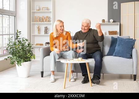 Mature couple playing jenga at home Stock Photo