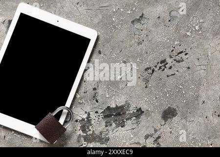 Padlock with tablet computer on grunge background. Cyber security concept Stock Photo