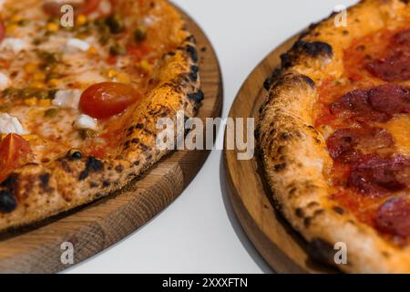 Pizza set with meat and cheese. Pepperoni pizza with arugula and prosciutto. Meat pizza with cheese, cherry tomatoes and hot jalapeno pepper on a whit Stock Photo