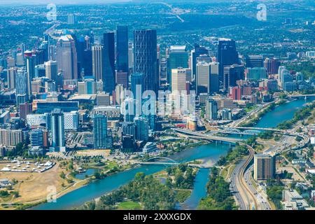 Aerial view of Calgary downtown skyline in Summer taken from an airplane showing city landmarks including Calgary Tower and the Bow River winding thro Stock Photo