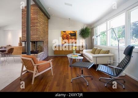 Modern 50's living room with floor to ceiling brick fireplace Stock Photo