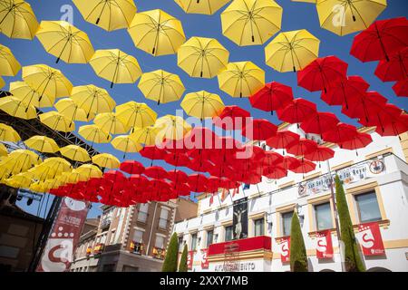 Madrid, Spain. 26th Aug, 2024. Umbrella-shaped ornament with the colors of the Spanish flag adorn the town hall square of San Sebastian de los Reyes, Madrid. As every year, the Madrid town of San Sebastian de los Reyes has started this morning the celebration of its patron saint festivities and as part of them its bull runs and bullfights. Credit: SOPA Images Limited/Alamy Live News Stock Photo