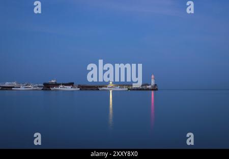 Lighthouse on pier with boats. Yalta, Crimea, Ukraine, Europe Stock Photo