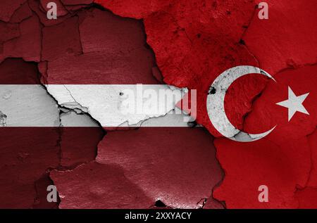 Flags of Latvia and Turkey painted on cracked wall Stock Photo