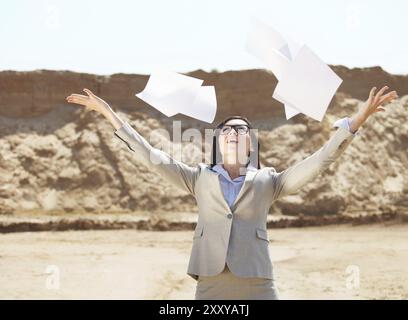 Too many paper work. Portrait of the brunette business woman in a desert Stock Photo