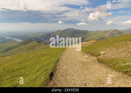 Walking down from Mount Snowdon on the Llanberis Path, Snowdonia, Gwynedd, Wales, UK, looking north towards Llyn Padarn and Llanberis Stock Photo